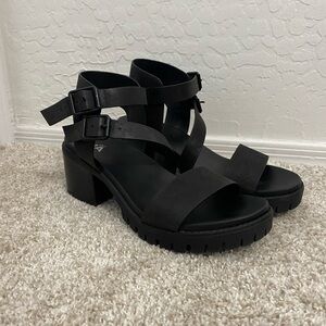 Black chunky platform sandals with adjustable ankle straps